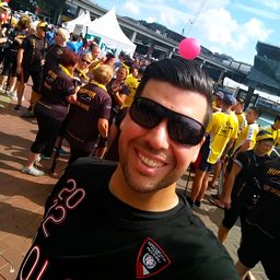 Ricardo Uzcategui smiling in sunglasses at an outdoor event